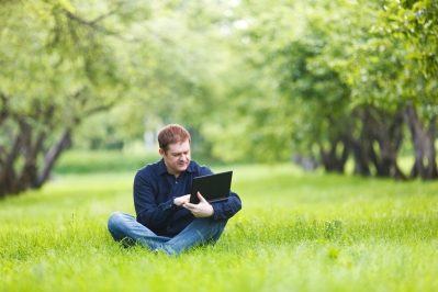 Man working with notebook in the park.